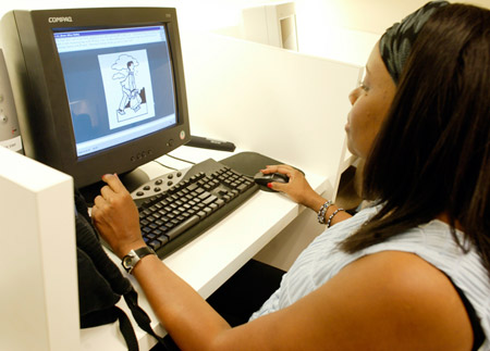 A job seeker performs a skills test at a staffing firm in Los Angeles. Minorities have fared poorly in the job market since the recession began more than a year ago. (AP/Damian Dovarganes)