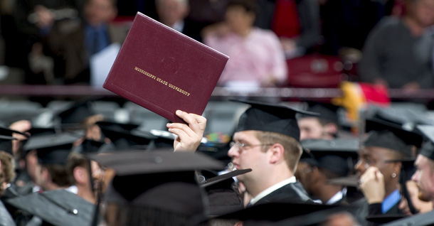 A college graduate holds up a diploma during a graduation ceremony. In his speech to Congress Tuesday night, President Obama set a goal for the United States to again become the world leader in number of college graduates. (AP/Mississippi State University, Megan Bean)