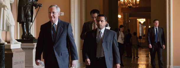 Senate Minority Leader Mitch McConnell (R-KY) walks through the Capitol on the way to a news conference as work on the economic stimulus bill continues. (AP/J. Scott Applewhite)