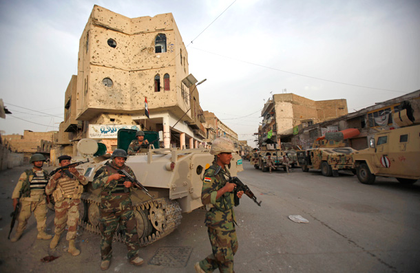 Iraqi soldiers patrol during search operations after a gunfight sparked Saturday at the dominantly Sunni neighborhood of Fadhil in Baghdad. U.S. and Iraqi troops exchanged gunfire Sunday with Sunni militants in central Baghdad in a second day of clashes following the arrest of a local leader of Sunni security volunteers who had broken with Al Qaeda. (AP/Hadi Mizban)