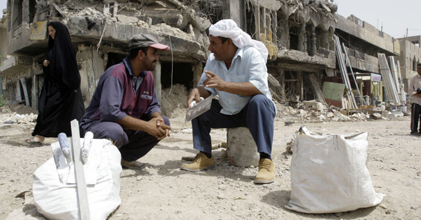 Manual laborers sit as they wait to be employed in Baghdad's Shiite enclave of Sadr City, Iraq, last year. As the United States reduces its military presence in Iraq, it should lead a truly international effort to help Iraq build its political institutions and advance the economic well-being of its people. (AP/Khalid Mohammed)