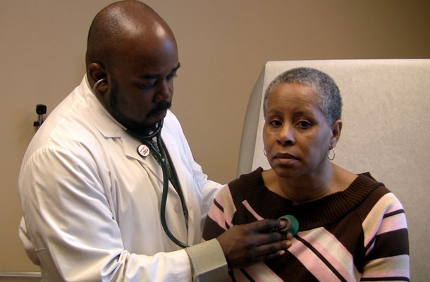 Sharron Moore, right, is examined by Dr. Patrick Antoine at the Southside Medical Center in Atlanta March 4, 2009. More than a third of Medicaid expenditures are devoted to long-term care services—at home and in the community as well as in nursing homes. (AP/Johnny Clark)
