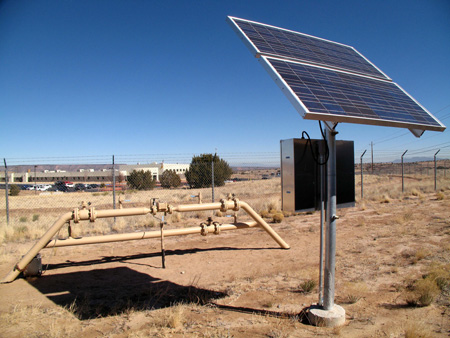 A solar panel powers a series of spotlights that highlight the New Mexico National Guard sign outside the Guard's compound in Rio Rancho, NM. The Guard is making clean energy the focus of a mission for all its units statewide. (AP/Susan Montoya Bryan)