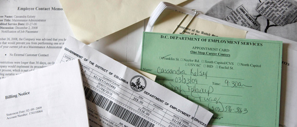 A Washington, DC woman sorts through her increasing pile of health insurance and unemployment paperwork. (AP/Jacquelyn Martin)