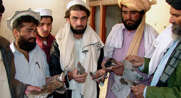 Pakistani tribesmen show pieces of missile in a house damaged by a suspected U.S. missile in Zharki village, near Miran Shah, in the Federally Administered Tribal Areas along Pakistan's border with Afghanistan. (AP/Hasbunallah Khan)