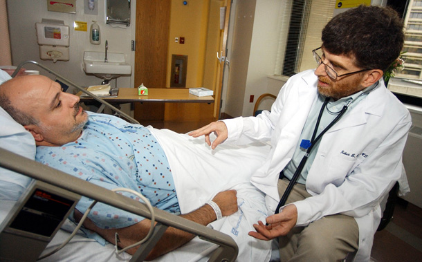 Dr. Robert Arnold, right, talls with one of his patients, Paul Lockwood, at UPMC Presbyterian hospital in Pittsburgh. President Obama has moved to rescind the midnight Bush "conscience" regulation governing health care providers. (AP/Keith Srakocic)