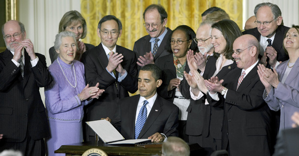 President Barack Obama is applauded by members of Congress, and others, after signing an executive order on stem cells and a Presidential Memorandum on scientific integrity, Monday, March 9, 2009, in the East Room of the White House in Washington. (AP Photo/Ron Edmonds)