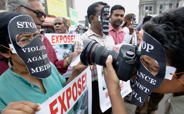 A photo journalist wearing a black mask shoots as he participates in a protest rally against attacks on free media in Colombo, Sri Lanka on January 26, 2009. The Committee to Protect Journalists identified the traditionally repressive regimes that continue to threaten a free press. (AP/Gemunu Amarasinghe)