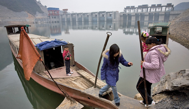 Villagers board a boat near the Xiaoxi dam in Changsha, China. At a speech in China last week, John Podesta spoke of seeking new pathways for the United States and China to collaborate on the challenges of climate change and energy security. (AP/Andy Wong)