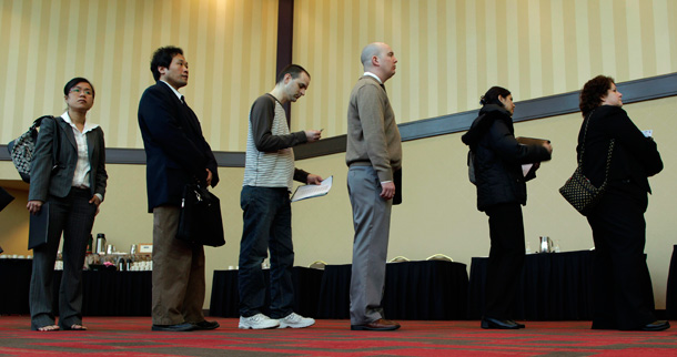 Job seekers wait in line at a career fair in Bellevue, Washington. The unemployment rate rose to 8.5 percent in March. (AP/Ted S. Warren)