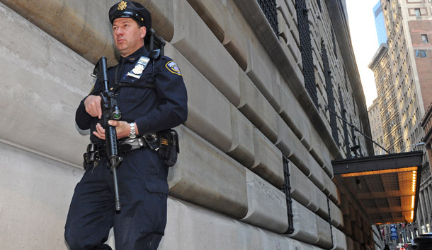 An armed officer patrols the Federal Reserve Bank in New York on April 24, 2009. Financial regulators must ensure that those familiar with the "stress test" results—and their friends and family—do not profit off that information. (AP/Louis Lanzano)