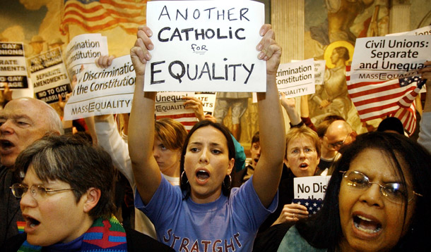 Rev. Anne Rousseau, of the United Church of Christ, left, Sonia Chang, of Boston, center, and Rev. Patricia Walton, also of the UCC, right, chant slogans in favor of same-sex marriage outside the House Chamber at the Statehouse in Boston. (AP/Steven Senne)