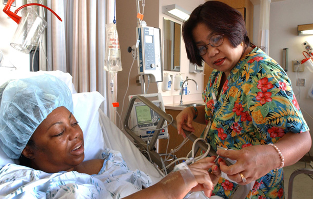 Zenaida Same, a California Registered Charge Nurse, helps patient Debra Jackson as she recovers from hip replacement surgery at Kaiser Permanente Los Angeles Medical Center. Health reform will make it easier for health professionals to serve patients to the best of their abilities.