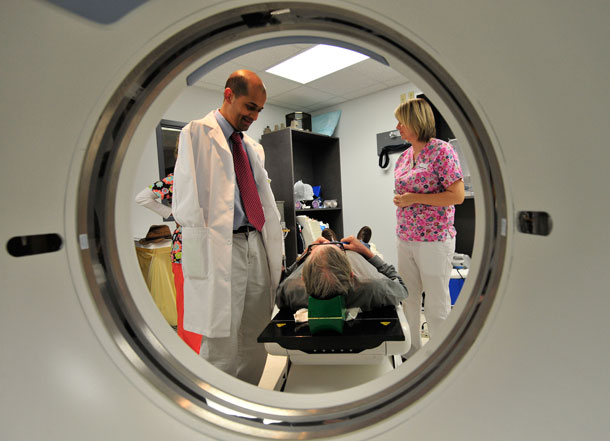 Dr. Hejal Patel, left, talks to Cody Helms, a cancer patient preparing to undergo CT treatment planning on March 19, 2009 at Patel's clinic in Dothan, AL. Patients must be able to have confidence that health care workers will put their lives and well-being first, especially when conflicts over moral beliefs arise. (AP/ Kevin Glackmeyer)