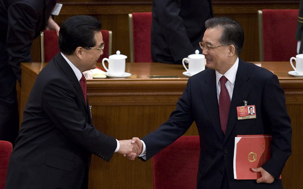 Chinese President Hu Jintao, left, greets his Premier Wen Jiabao, right, at the closing ceremony of the National People's Congress at the Great Hall of the People in Beijing on March 13, 2009. China's leaders are serious about pulling their country out of the current economic crisis and helping its trading partners in East Asia do so as well. (AP/Andy Wong)