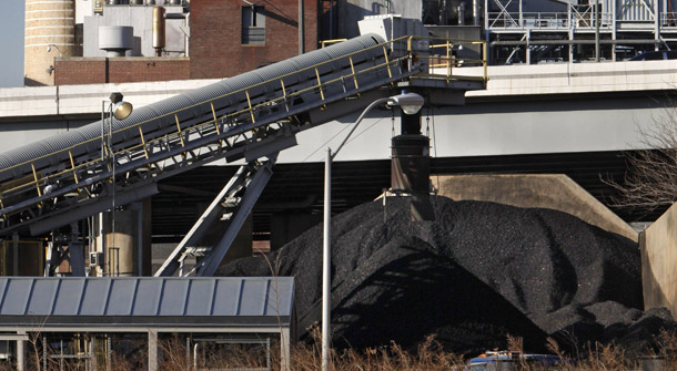 Coal is piled beside the Capitol Power Plant, a coal-burning electrical plant, in Washington, on February 25, 2009. Big coal front group ACCCE still talks clean coal but spends little on the research to advance it. (AP/Jacquelyn Martin)