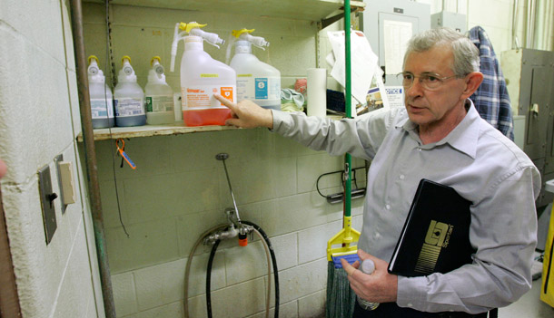 Ken Kirkland, custodial manager at Lockport Township High School in Lockport, Illinois, shows environmentally friendly cleaning supplies that janitors use to clean the school. (AP/Charles Rex Arbogast)