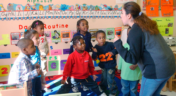 Teacher Shelly Utreras, right, plays a game with a class of three- and four-year-olds at the Friendly Fuld Neighborhood Center in Newark, N.J. (AP/Mike Derer)