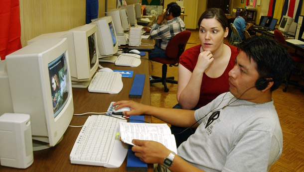 An English instructor reacts at a selection Artemio Salvador of Guatemala, right, makes during his class in Forest, MS. Immigrants face many challenges beyond learning English, and a federal office is needed to coordinate these challenges across agencies. (AP/Rogelio Solis)