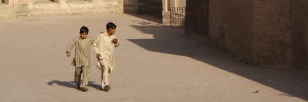 Children run across a square in Lahore, Pakistan. (CAP/Colin Cookman)