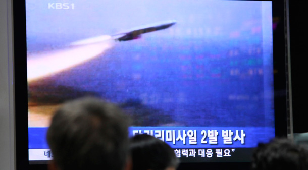 South Koreans at the Seoul Railway Station watch a television broadcasting on North Korea's reported missle and nuclear tests.
<br /> (AP/Ahn Young-joon)