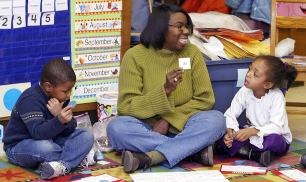 Teacher Angela Lively plays word bingo with her class. Lively keeps a box of shoes so poor children can get a new pair when their old shoes won't fit. When she sends assignments home, she includes packets of crayons, glue sticks and scissors to make sure students have supplies to finish projects. (AP/Michael Conroy)