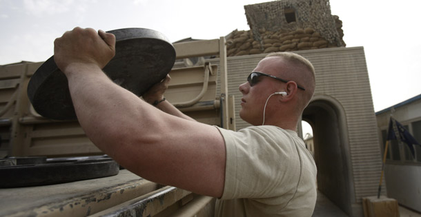Olin Williams loads gym equipment on a truck as his unit prepares to turn over their base to the Iraqi security forces in the Hurriyah neighborhood in Baghdad. (AP/Dusan Vranic)