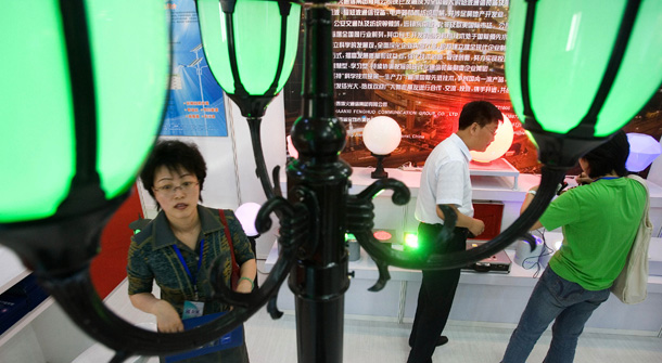 Visitors walk by the latest street lamps using the energy efficient LED, or Light Emitting Diodes, during an exhibition about energy saving technologies in Beijing, China.
<br /> (AP/Ng Han Guan)