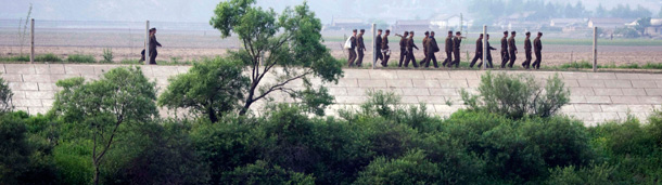 North Korean soldiers march along the border fence on the North Korean side bordering China near Dandong, northeastern China's Liaoning province. (AP/Ng Han Guan)
