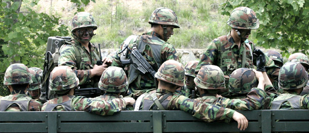 South Korean Army soldiers board a military truck during a military exercise against a possible attack by North Korea on June 8, 2009. Defense Secretary Robert Gates has deployed credible missile defense systems in response to the threat of North Korean missile tests. (AP/Ahn Young-joon)