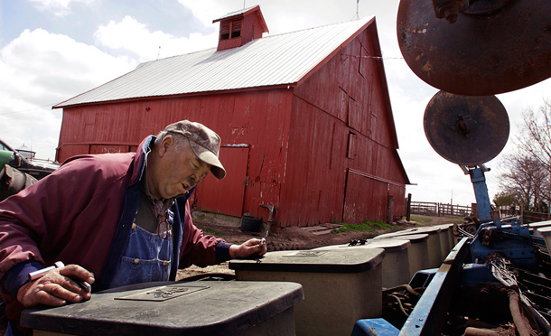 Corn and soybean farmer Ed Mies works to repair a seed planter on his farm near Loami, Ill. Farmers can benefit from numerous provisions in the American Clean Energy and Security Act. (AP/Seth Perlman)