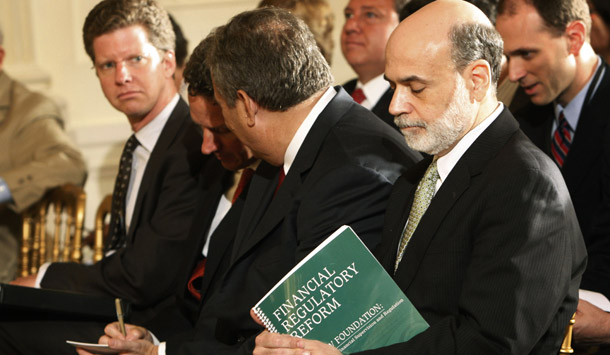 Federal Reserve Chairman Ben Bernanke, right, holds a copy of the outlined reforms as he waits to hear the remarks by President Barack Obama on the new comprehensive financial regulatory reform plan on June 17, 2009. (AP/Pablo Martinez Monsivais)