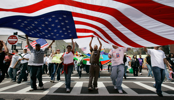 Participants in a march for immigration reform carry a large American flag. (AP/Charles Rex Arbogast)