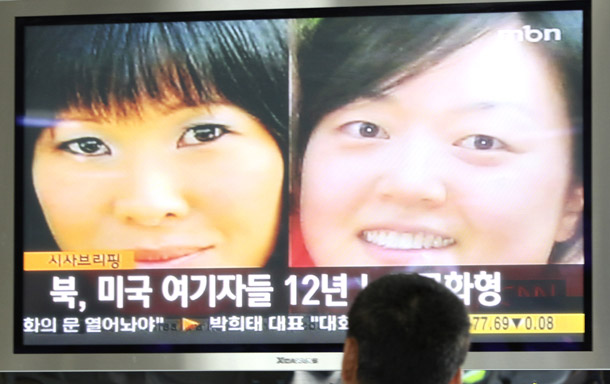 A South Korean man watches a TV broadcasting news about two American journalists detained in North Korea at the Seoul Railway Station, in South Korea. There are a total of 29 countries that jail journalists. (AP/Ahn Young-joon)