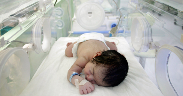 A newborn baby sleeps at the premature birth unit of a hospital. (AP/Ibrahim Usta)