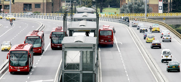 Transmilenio municipal buses are seen on a street of Bogotá, Colombia. (AP/Fernando Vergara)