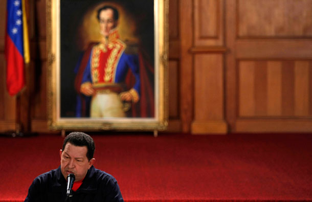 Venezuela's President Hugo Chávez pauses during a news conference at the Miraflores presidential palace in Caracas, Venezuela, on July 10, 2009. Chávez calls himself the new Simón Bolivar, whose portrait is shown on the background, yet his politics contradict those of the legendary commander in chief.
  (AP/Fernando Llano)