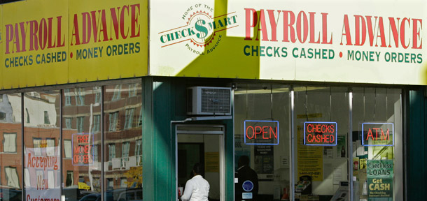 A customer enters a Payroll Advance location in Cincinnati, OH. The Center for Responsible Lending released a report yesterday verifying that payday lending often “traps” borrowers in a cycle of borrowing. (AP/Al Behrman)