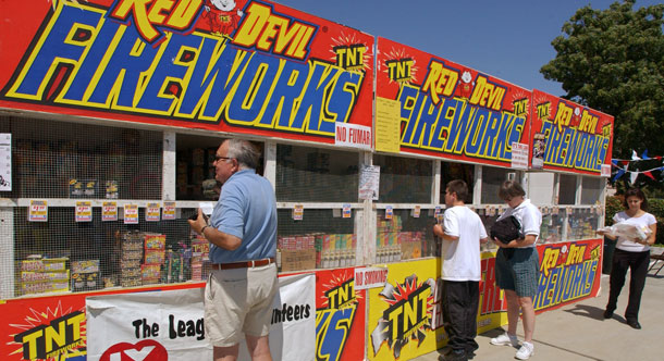 Customers purchase legal fireworks at a stand in Newark, CA, in preparation for the Fourth of July festivities. Eco-friendly fireworks are available for home use, but be sure to check your state laws on firework control before you buy and use them.
  (AP/Paul Sakuma)