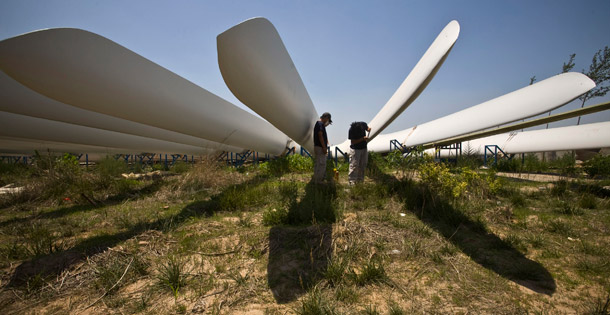 Workers paint wind turbine blades at a factory in Baoding, China. (AP/Alexander F. Yuan)