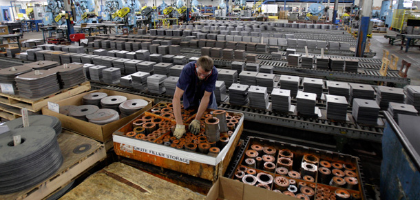 An employee at Baldor Electric Co. works inside the company's factory in St. Louis. A new government report shows the economy sank at a pace of just 1 percent in the second quarter of the year. It was a better-than-expected showing that provided the strongest signal yet that the longest recession since World War II is finally winding down. (AP/Jeff Roberson)