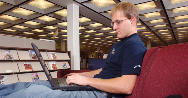 A student at Black Hills State University takes an online course in the library of the campus. The House Student Aid and Fiscal Responsibility Act of 2009 would help develop freely available and widely disseminated high-quality online courses that will help meet the educational and training needs of students in high school and college, and among adult workers. (AP/Johnny Sundby)