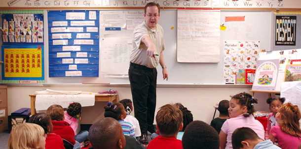 West Boulevard Elementary teacher Steven Cook calls on one of the students of his first grade class. (AP/L.G. Patterson)