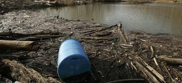 A plastic 55-gallon barrell is seen amongst piles of driftwood and mud along the Potomac River in Cropley, MD. The main culprit for the river’s deteriorating health is suburban sprawl due to a booming local population. (AP/Chris Gardner)