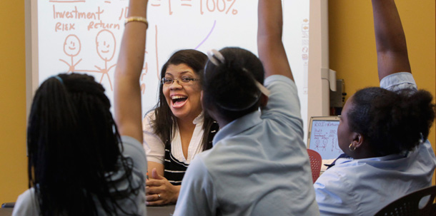 Students raise their hands to answer a question in a sixth grade class at a school on Chicago's South Side. (AP/Charles Rex Arbogast)