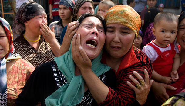 Uighur women grieve for their men who they claim were taken away by Chinese authorities after Sunday's protest in Urumqi, China, on July 7, 2009. A conflict between Han Chinese and ethnic minority Uighurs in the western Xinjiang Autonomous Region has left 156 dead and over 1,000 wounded in just three days. (AP/Ng Han Guan)