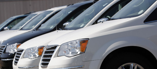 Town & Country minivans sit on a lot in Centennial, CO, last year. The recently observed increase in the savings rate can be largely attributed to lower energy prices and less spending on cars. (AP/David Zalubowski)