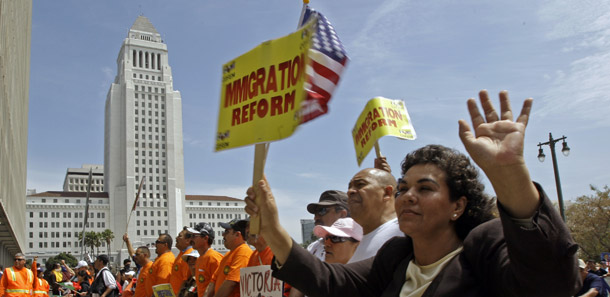 Demonstrators pass City Hall during a march and rally for immigration law reform in Los Angeles on May 1. Americans are looking for real solutions to immigration reform and health care. (AP/Reed Saxon)