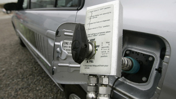 Natural gas can serve as a bridge fuel to a 21st-century energy economy that relies on efficiency, renewable sources, and low-carbon fossil fuels. Above, a Honda Civic GX fills up with natural gas. (AP/Kiichiro Sato)