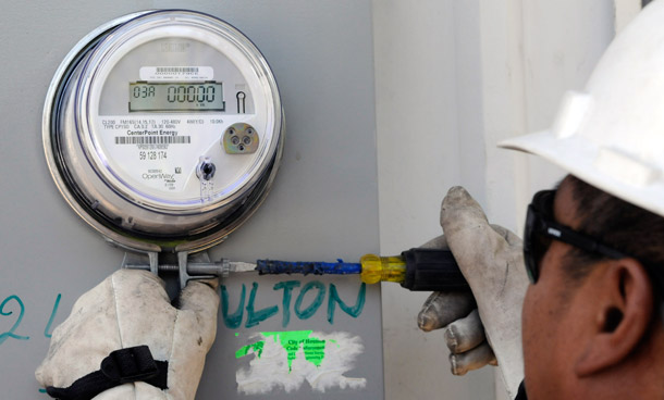 A worker installs a smart meter in Houston, a measure that will help maximize the building's energy efficiency. (AP/Pat Sullivan)